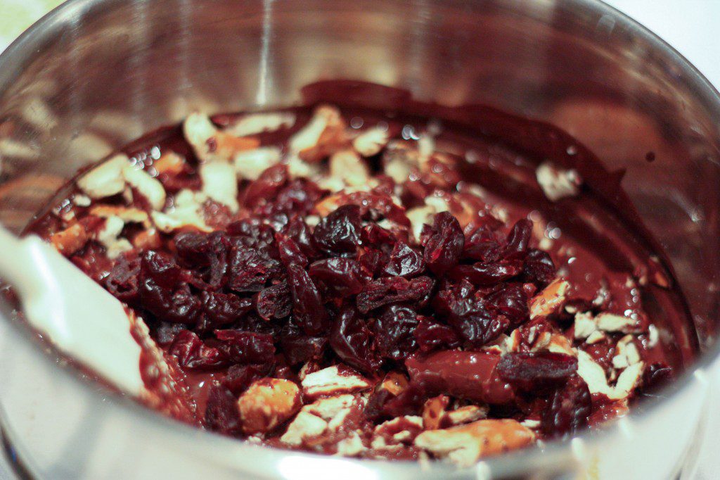 melted chocolate, cherries, and pretzels